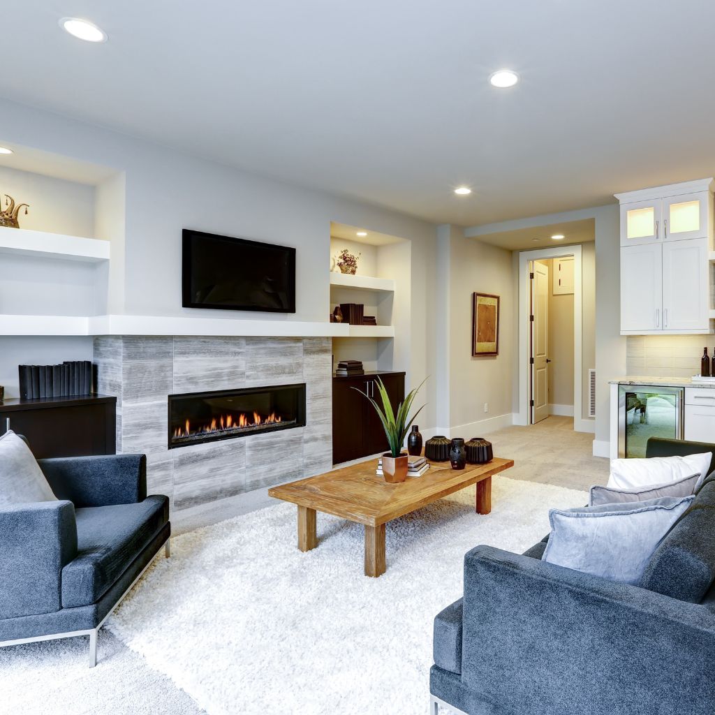 A living room with a fireplace and a flat screen tv.
