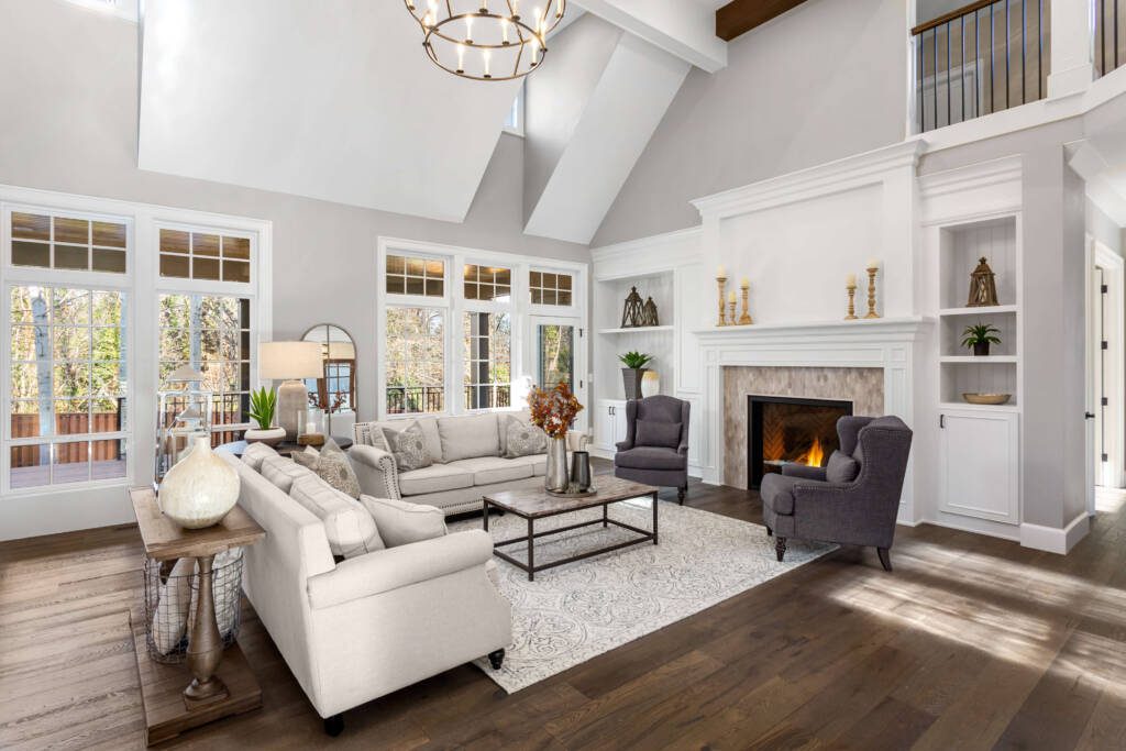 A living room with white furniture and fireplace.